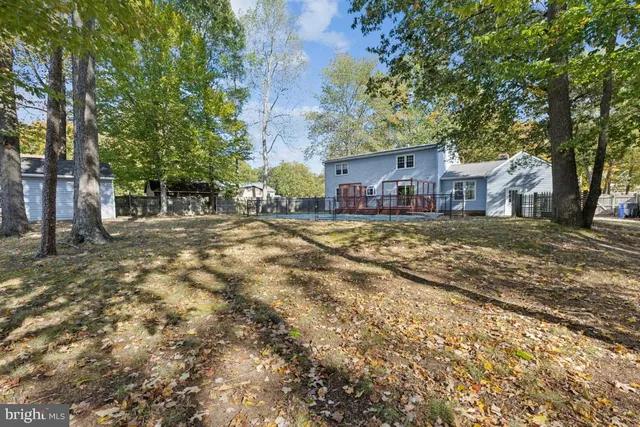 a view of a yard with a house and a tree