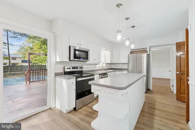 a kitchen with a sink stove and refrigerator