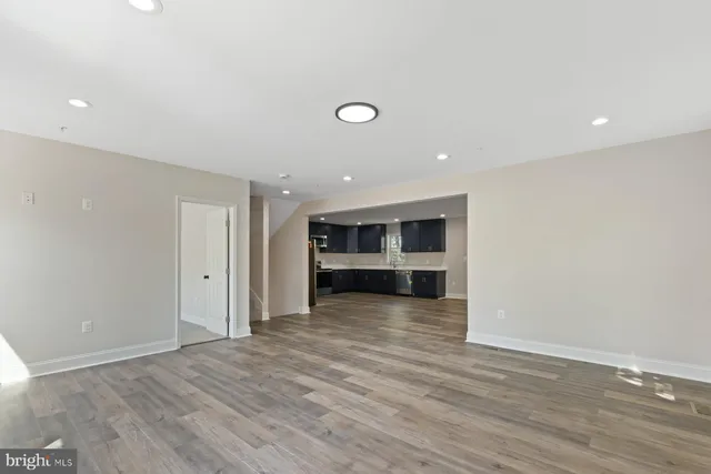 a view of a room with wooden floor and cabinet