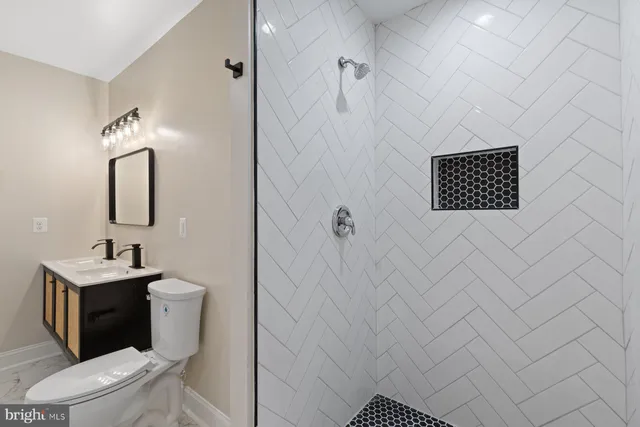 a bathroom with a toilet sink and mirror