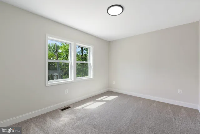 an empty room with a empty space and a window