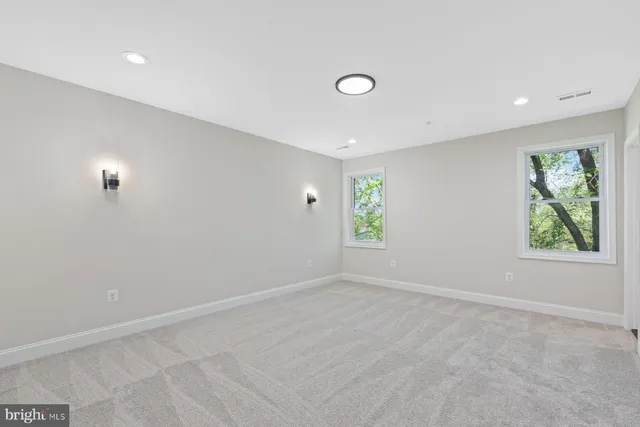 a view of an empty room and wooden floor