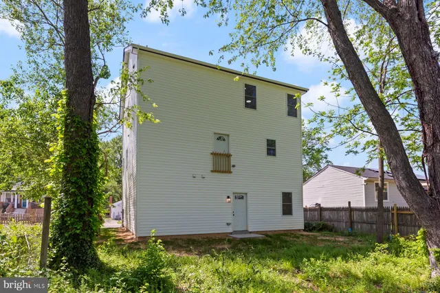 a view of a house with a tree beside a yard