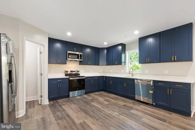 a large kitchen with wooden cabinets and stainless steel appliances