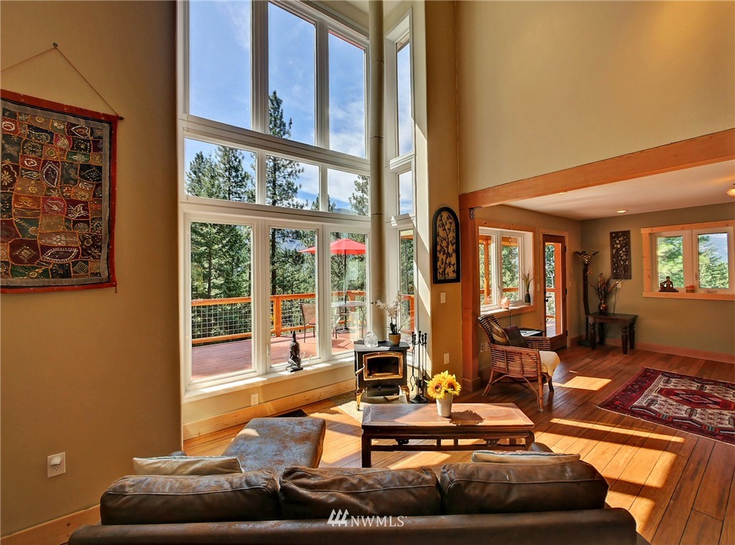41 Trillium Road Winthrop, WA 98862 - Photo 11 of 39 a living room with furniture and a floor to ceiling window