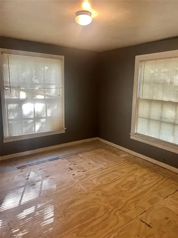 a view of a backyard and floor to ceiling window