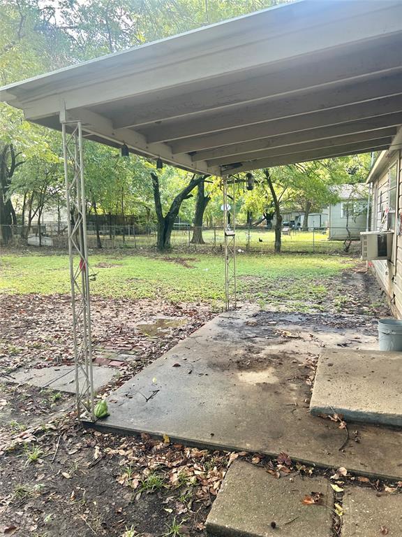 1016 North Howeth Street Gainesville, TX 76240 - Photo 13 of 15 a view of a backyard and floor to ceiling window