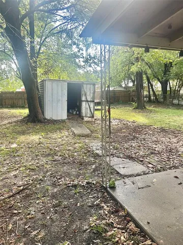 a big yard with large trees