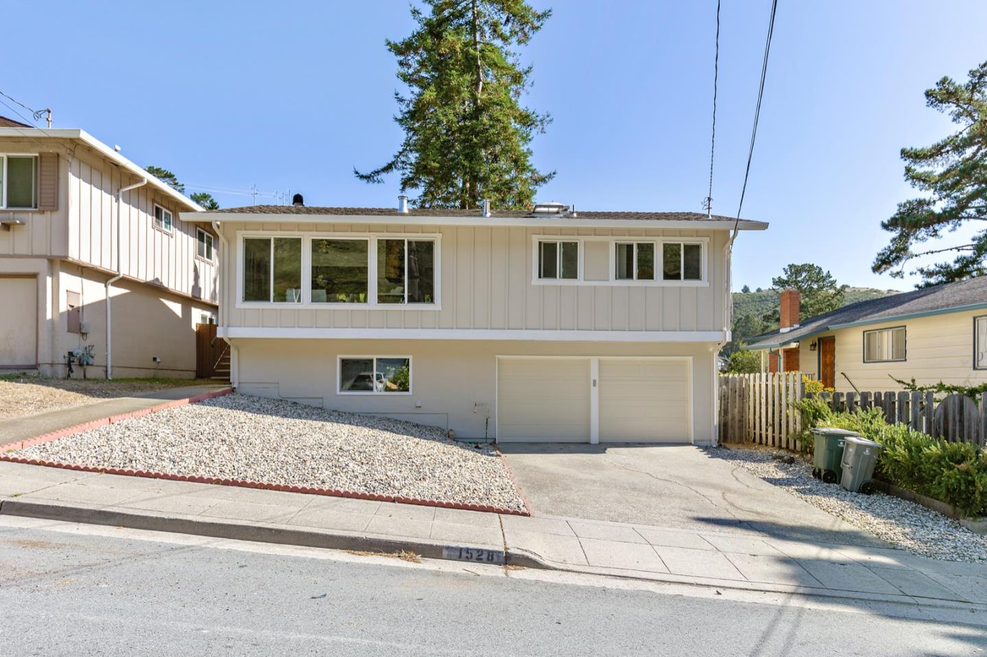 1528 Terra Nova Boulevard Pacifica, CA 94044 - Photo 1 of 32 a front view of a house with a yard and garage