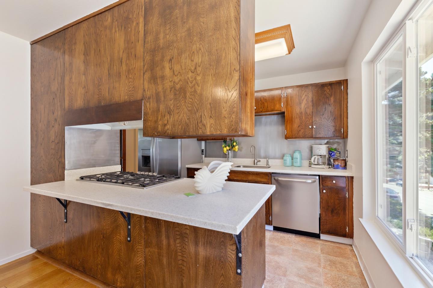 1528 Terra Nova Boulevard Pacifica, CA 94044 - Photo 13 of 32 a kitchen with a sink a stove and cabinets