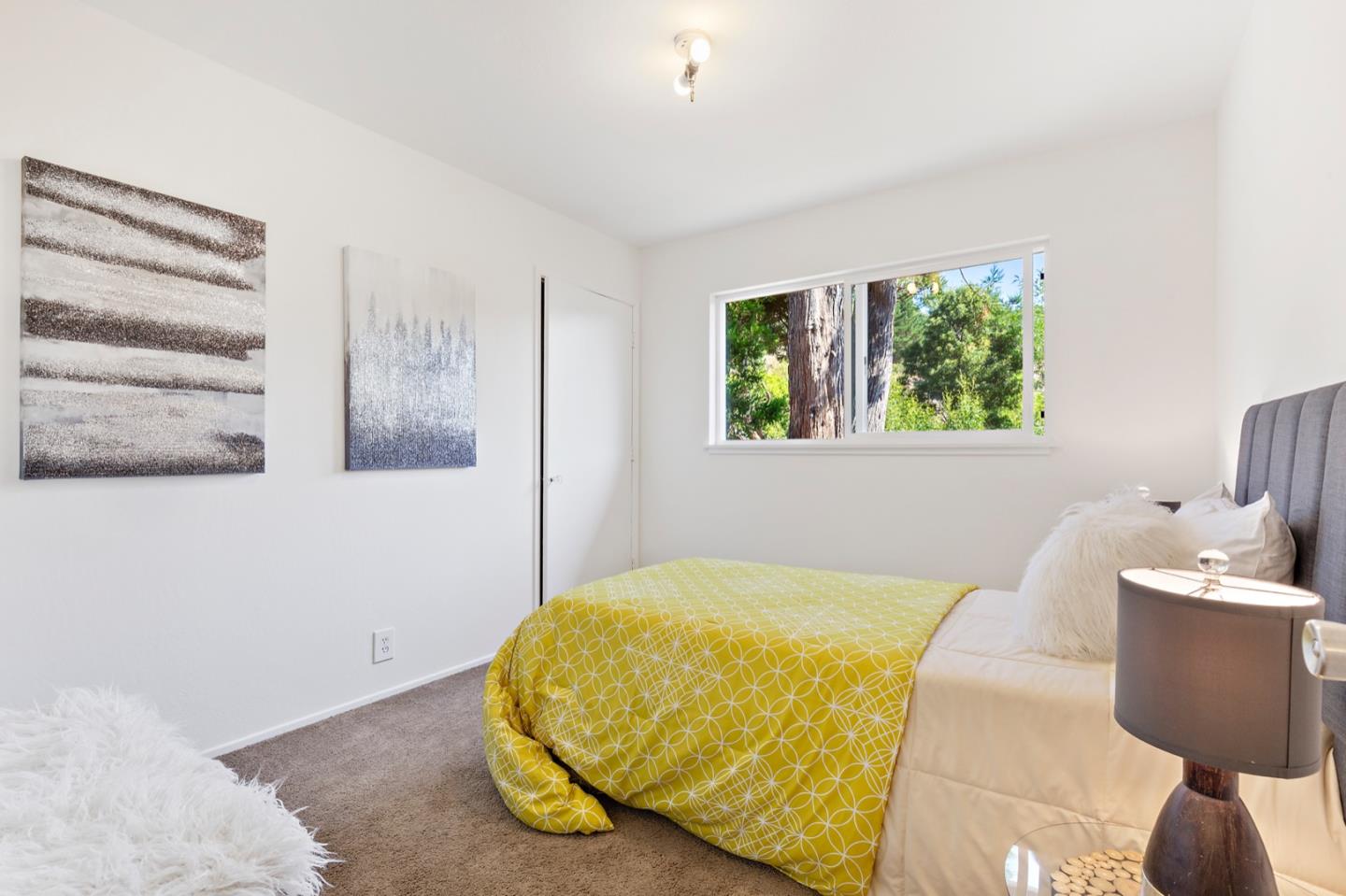 1528 Terra Nova Boulevard Pacifica, CA 94044 - Photo 20 of 32 a bedroom with a bed and wooden floor
