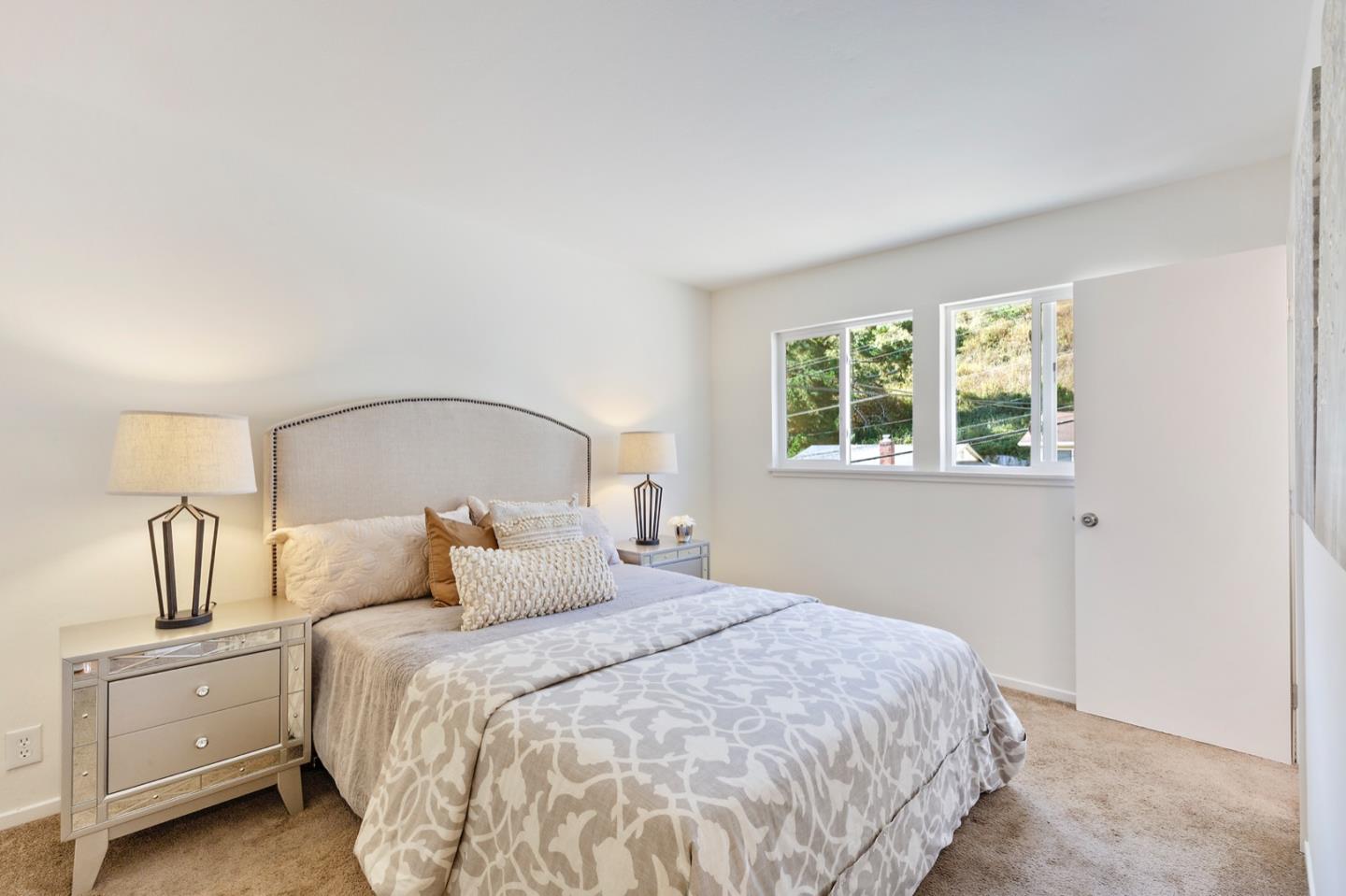 1528 Terra Nova Boulevard Pacifica, CA 94044 - Photo 22 of 32 a bedroom with a bed and window