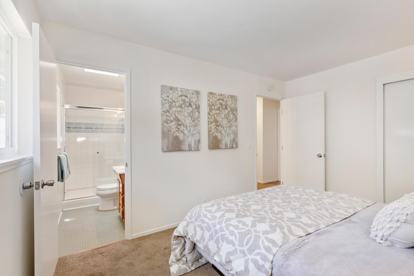 1528 Terra Nova Boulevard Pacifica, CA 94044 - Photo 23 of 32 a bedroom with a bed and a view of bathroom