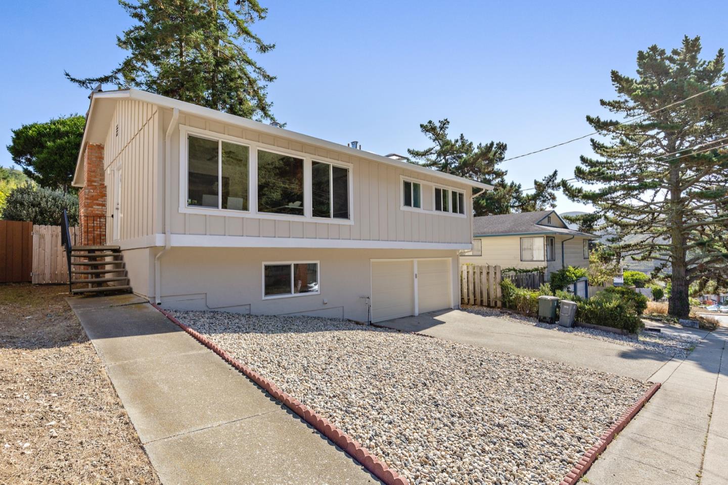 1528 Terra Nova Boulevard Pacifica, CA 94044 - Photo 3 of 32 a front view of a house with a yard and garage