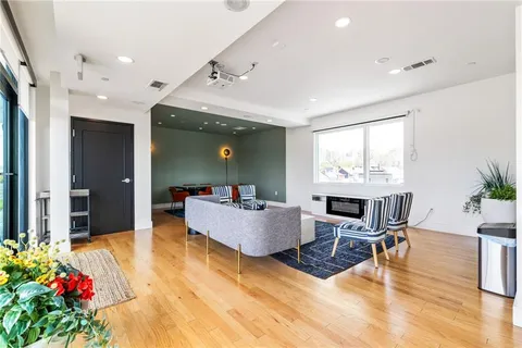 a view of a swimming pool with a bench and some trees