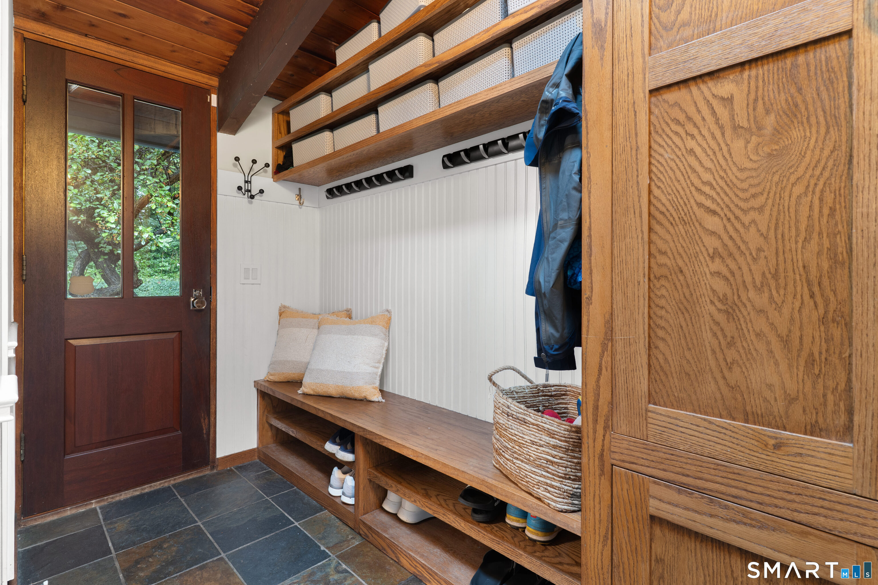 132 Signal Hill Road Wilton, CT 06897 - Photo 22 of 32 Mudroom with built in cabinets and bench, plus 1/2 bath.
