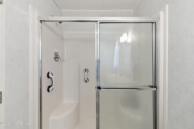a bathroom with a glass shower door