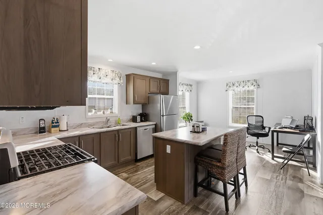 a kitchen with a sink and chairs