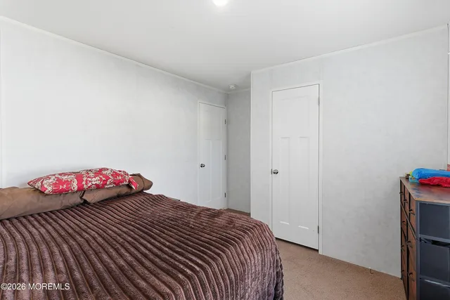 a bedroom with a bed and a table