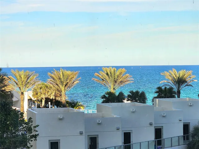 an aerial view of residential houses with outdoor space and swimming pool
