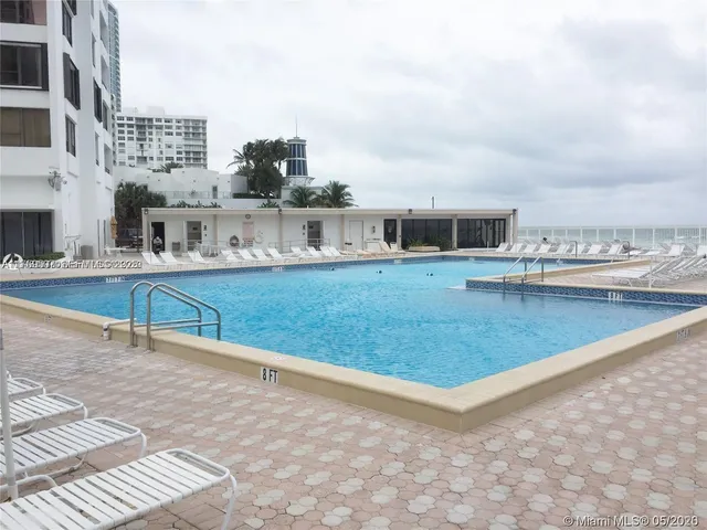 a view of swimming pool with outdoor seating