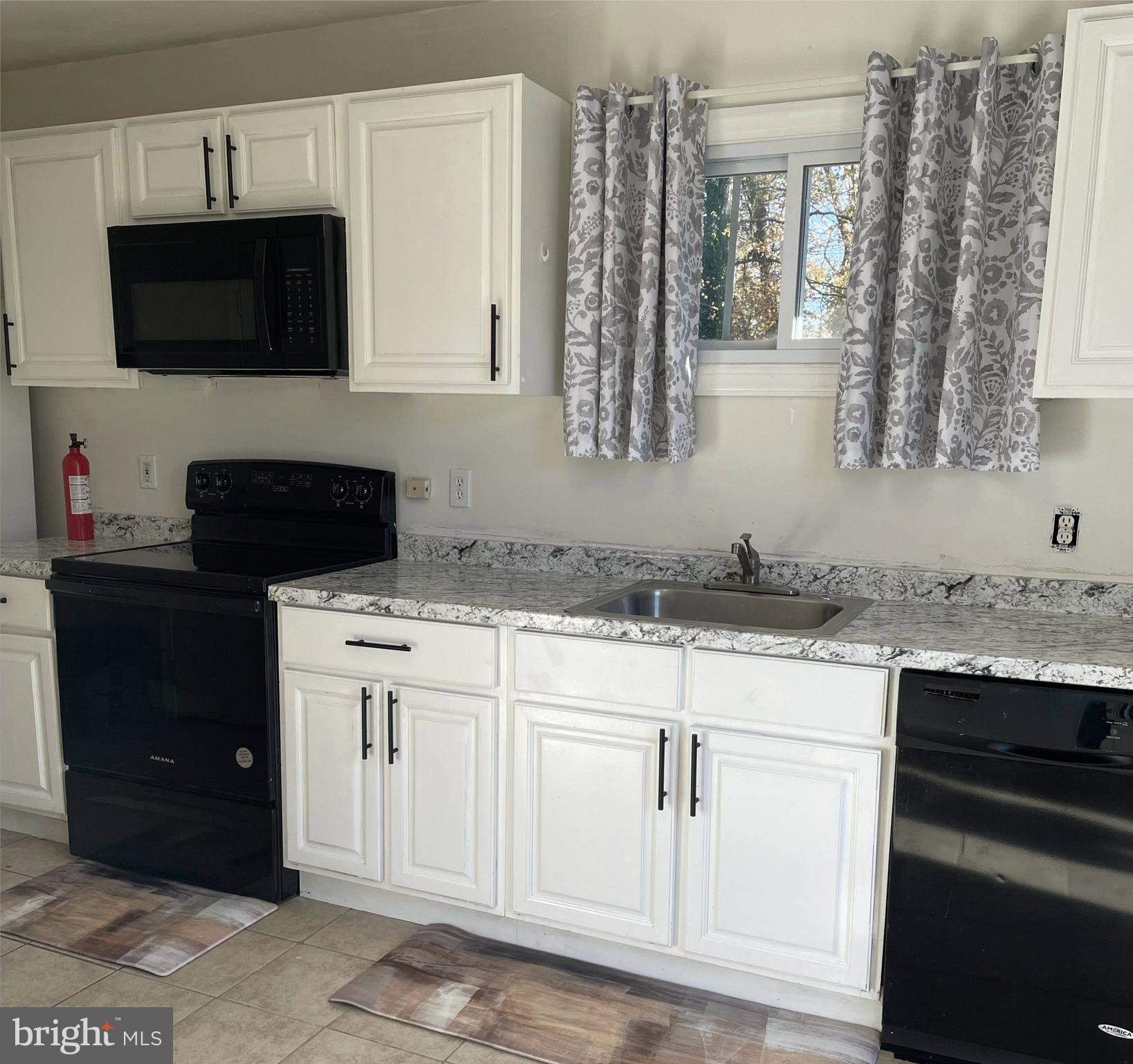 1902 Spencer Drive Croydon, PA 19021 - Photo 18 of 61 a kitchen with stainless steel appliances granite countertop a sink a stove and a microwave
