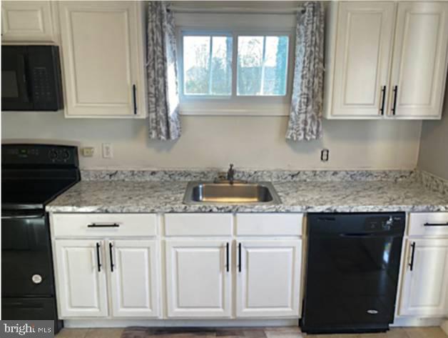 1902 Spencer Drive Croydon, PA 19021 - Photo 26 of 61 a kitchen with white cabinets and sink