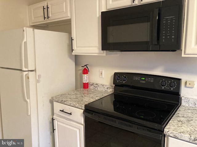 1902 Spencer Drive Croydon, PA 19021 - Photo 10 of 61 a kitchen with stainless steel appliances granite countertop a stove microwave and refrigerator