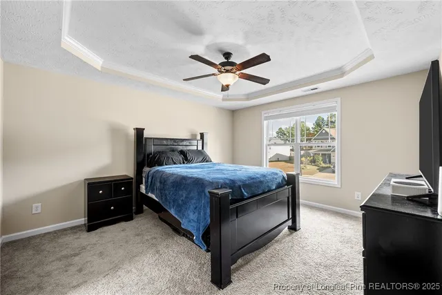 a bedroom with a bed and a tv on the dresser