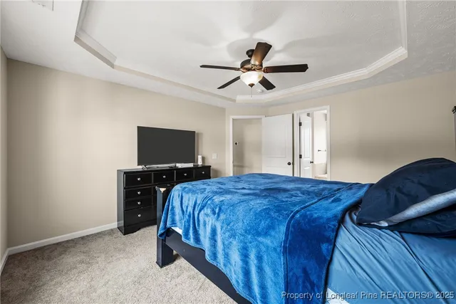 a bedroom with a bed and a flat tv screen on dresser