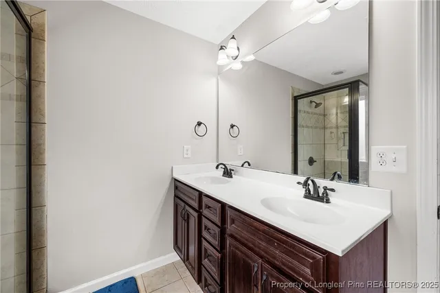 a bathroom with a sink double vanity and a mirror