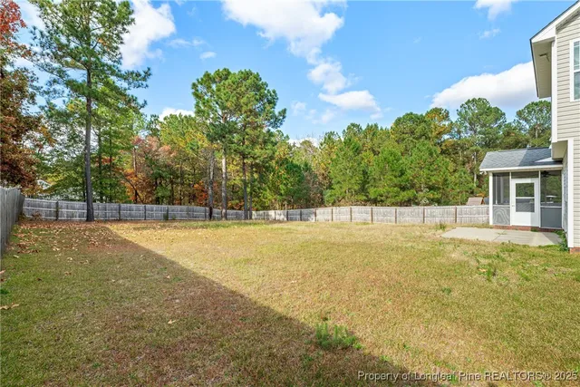 a view of a backyard with swimming pool