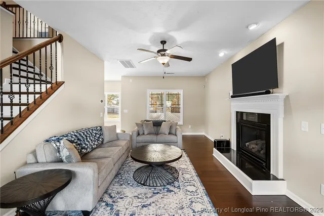 a living room with furniture fireplace and a flat screen tv