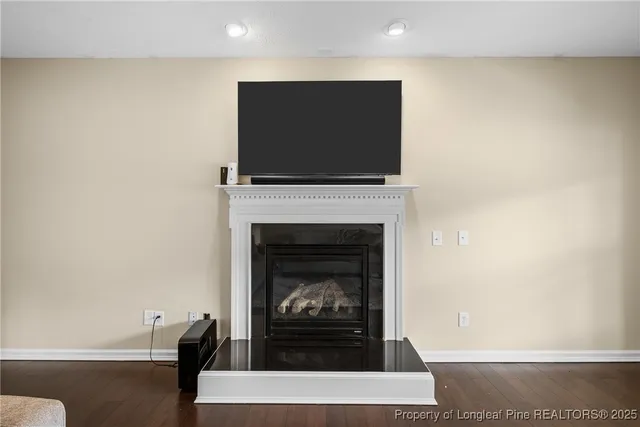 a living room with a fireplace and a flat screen tv