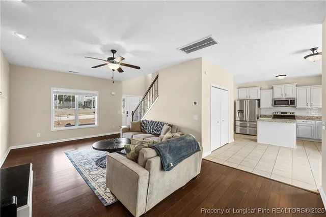 a living room with furniture and kitchen view