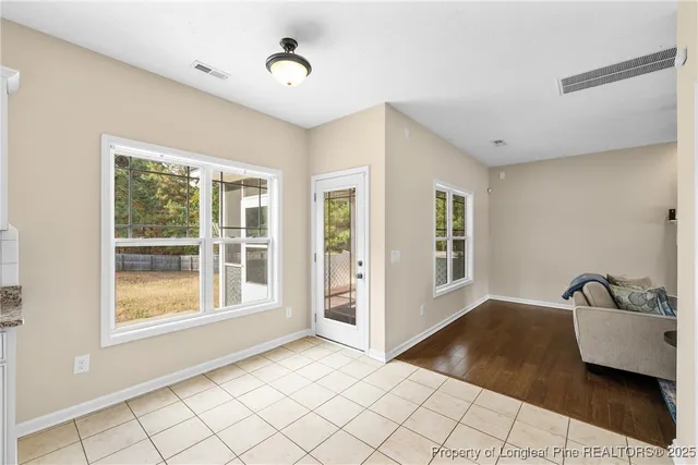 a view of a room that has a bed and a window in it