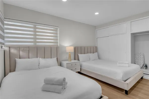 a bedroom with double bed and a large window
