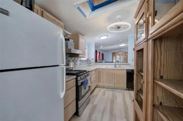 a kitchen with a refrigerator a sink and dishwasher