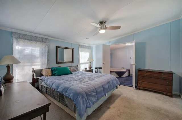 a spacious bedroom with a bed and a chandelier