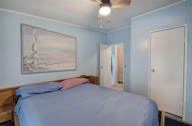 a bedroom with a bed and a painting on the wall