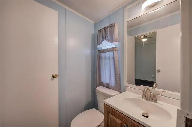 a bathroom with a toilet sink and mirror