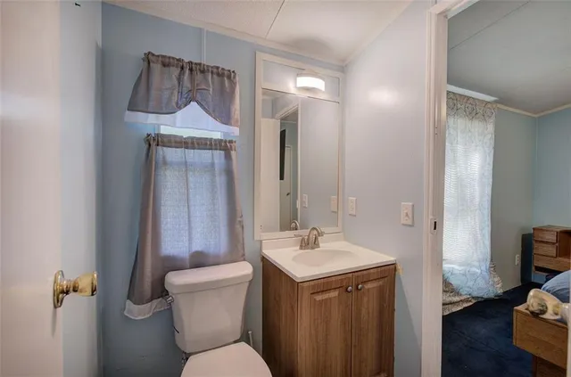 a bathroom with a toilet sink and mirror