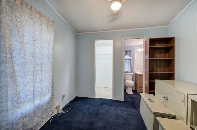 a view of empty room with a window and cabinet