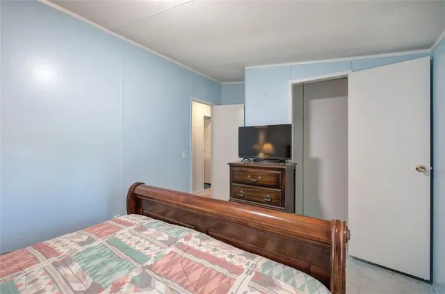 a bedroom with a bed and a television