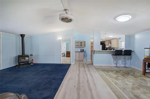 a view of kitchen and hall with wooden floor