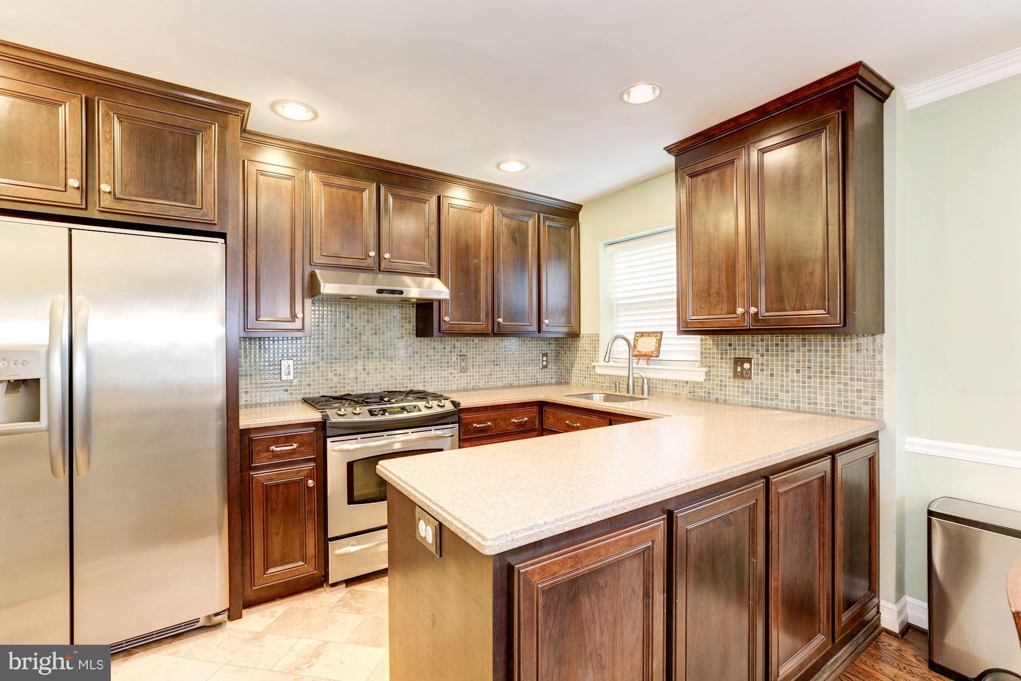 10016 Sidney Road Silver Spring, MD 20901 - Photo 3 of 25 a kitchen with a stove a refrigerator and a sink