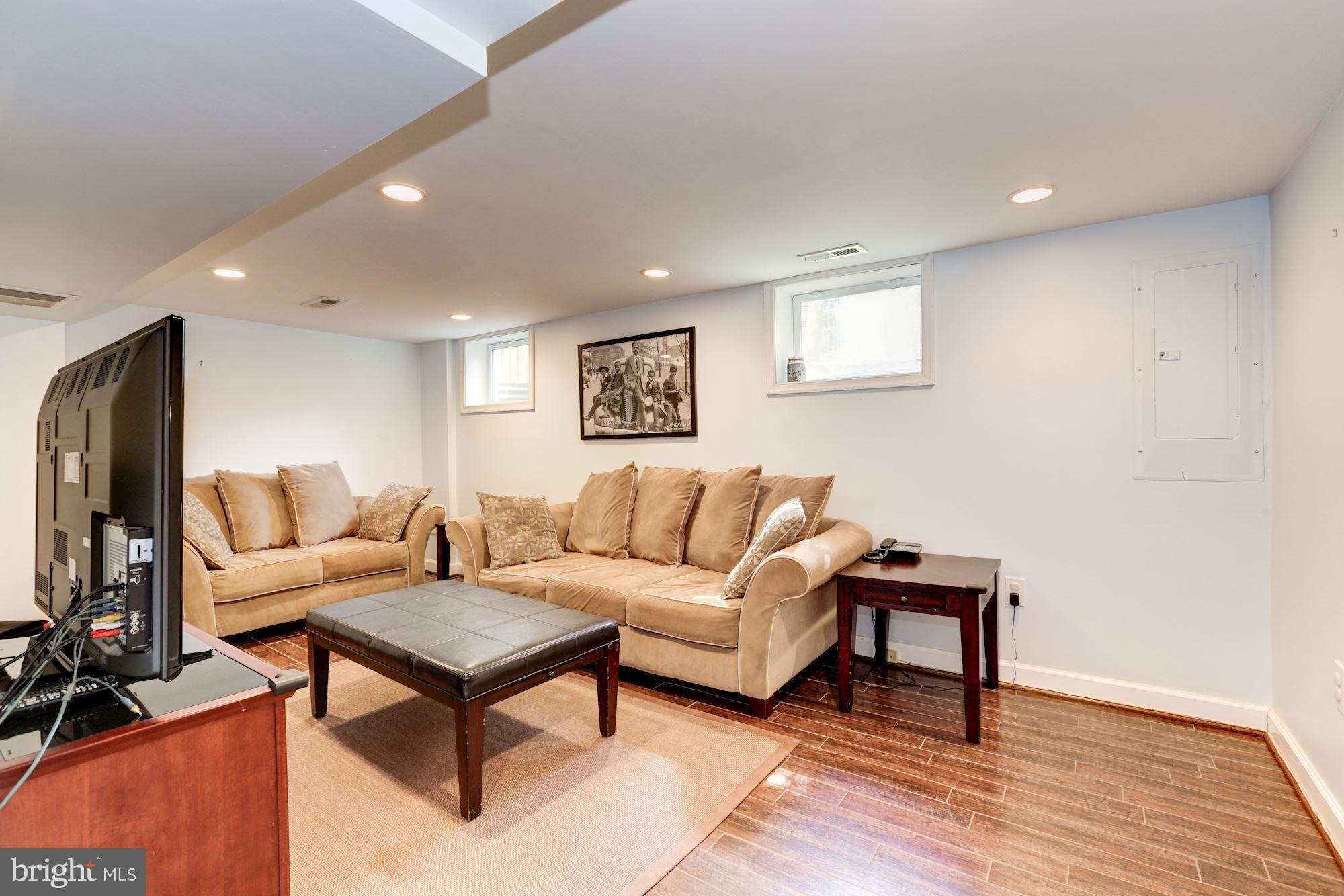 10016 Sidney Road Silver Spring, MD 20901 - Photo 21 of 25 a living room with furniture a flat screen tv and a table
