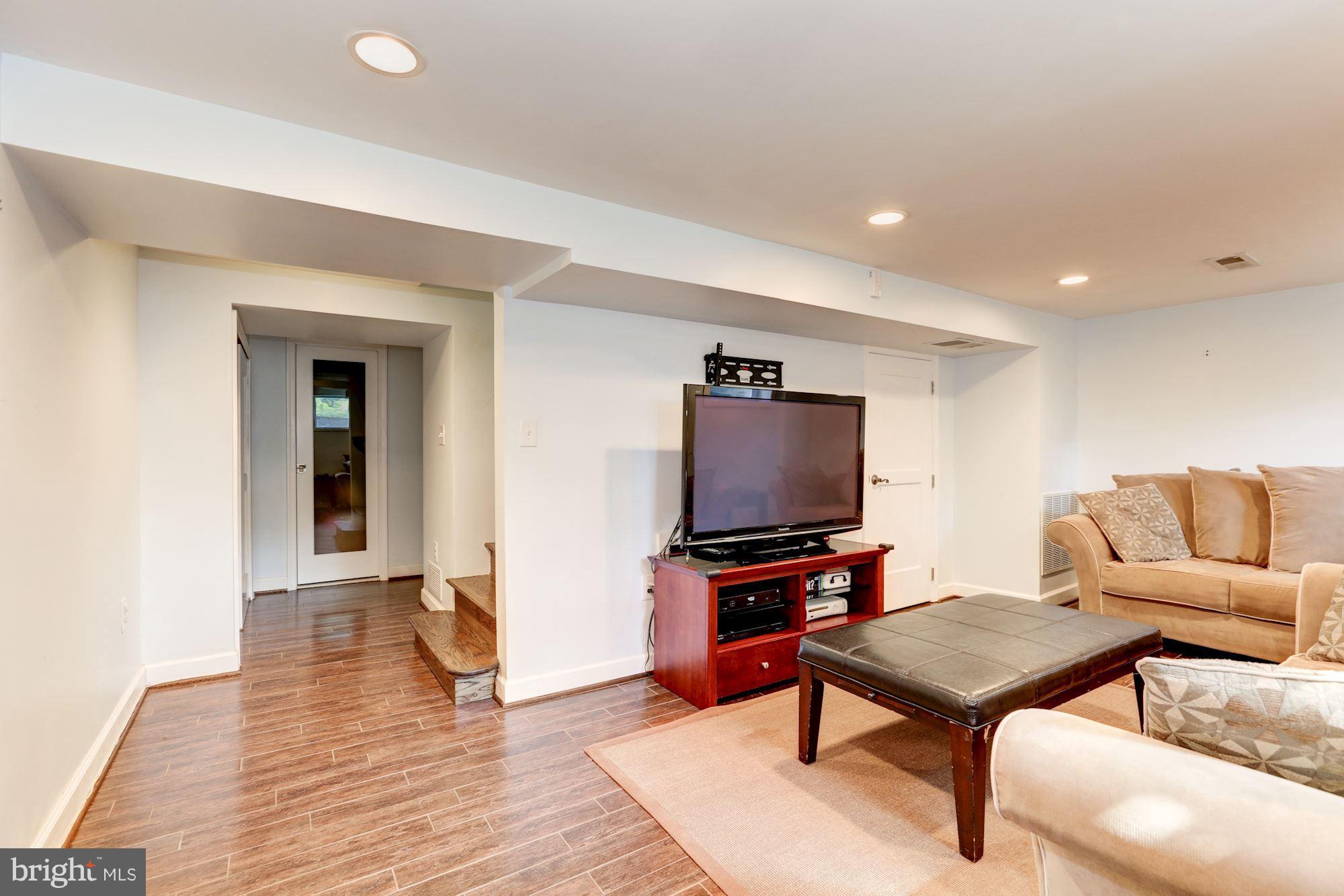 10016 Sidney Road Silver Spring, MD 20901 - Photo 22 of 25 a living room with furniture and a flat screen tv