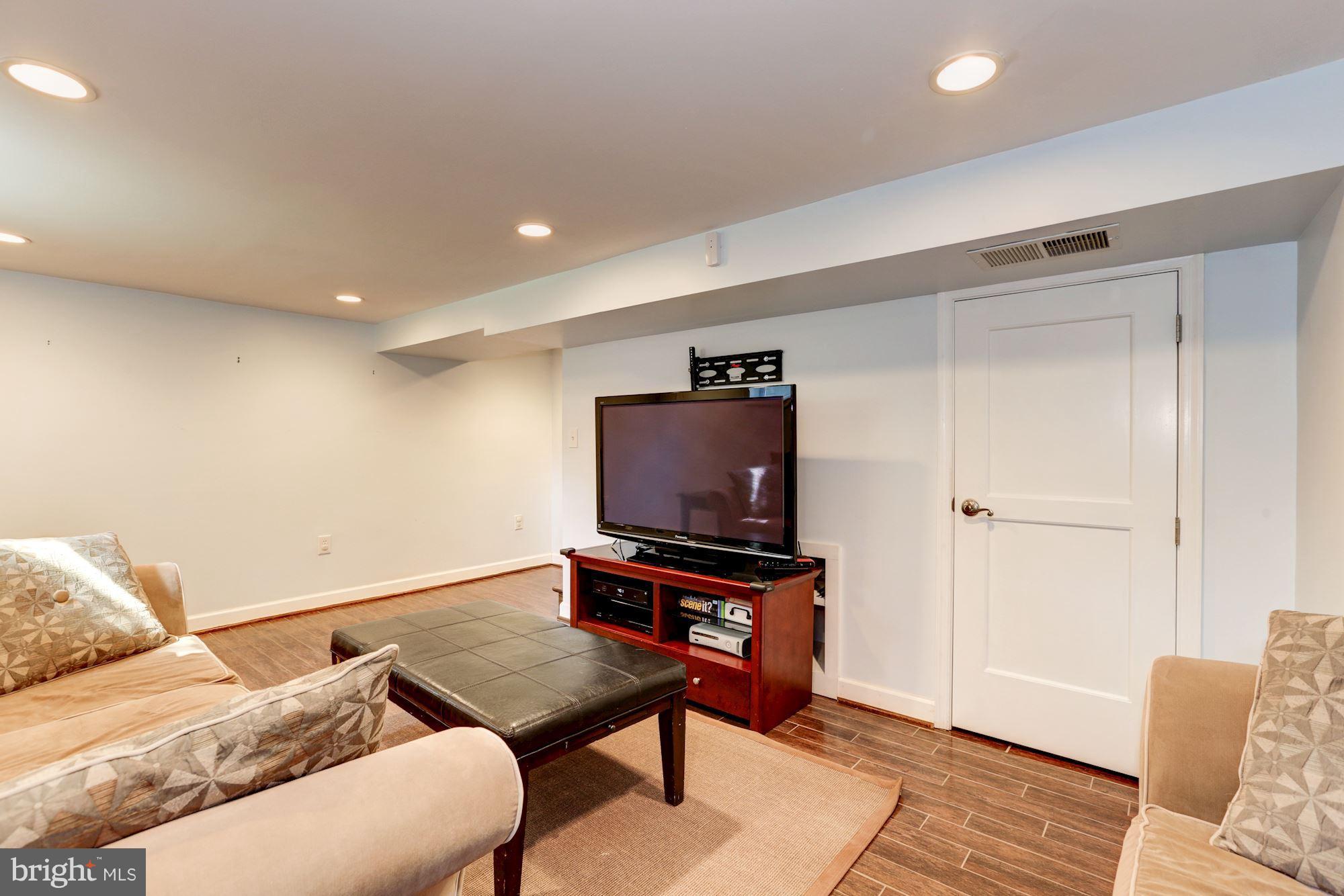 10016 Sidney Road Silver Spring, MD 20901 - Photo 23 of 25 a living room with furniture and a flat screen tv