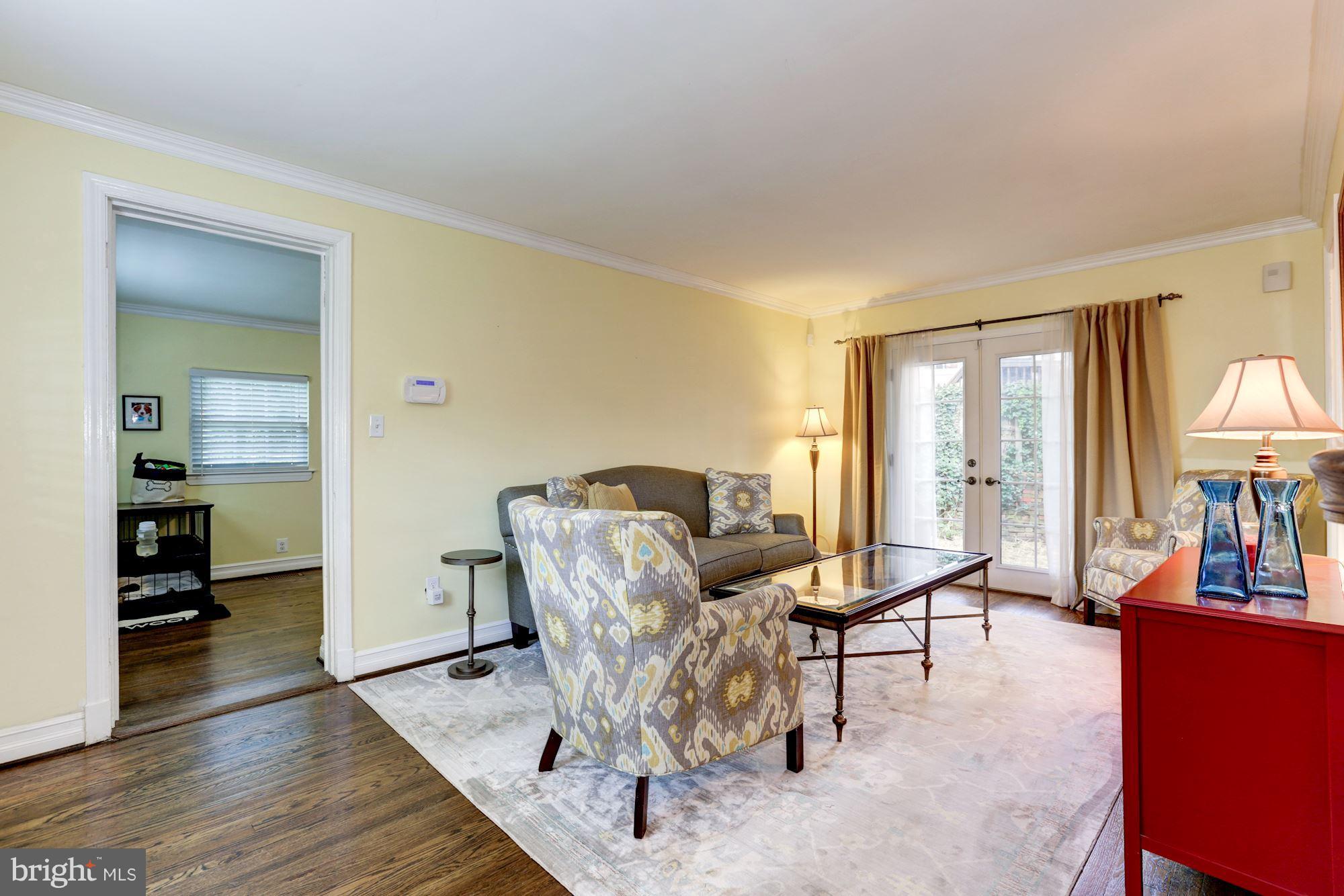 10016 Sidney Road Silver Spring, MD 20901 - Photo 10 of 25 a living room with furniture a large window and wooden floor